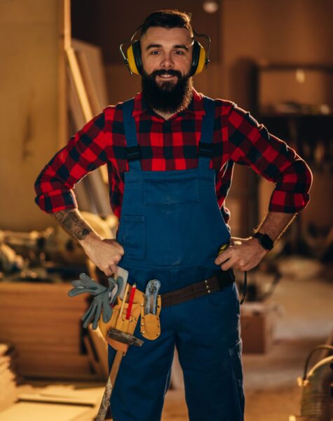 young-male-carpenter-working-in-workshop-and-weari-2023-11-27-05-10-20-utc